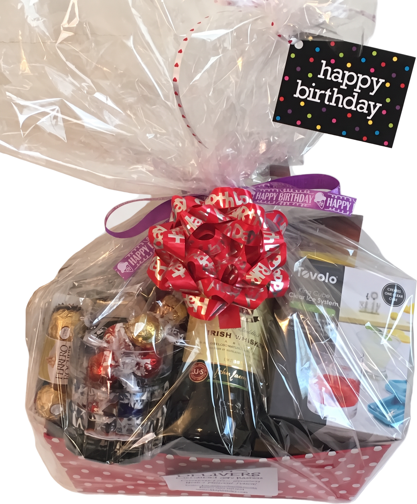 Birthday gift basket with sparkling wine, Irish whiskey, chocolates, and a happy birthday tag